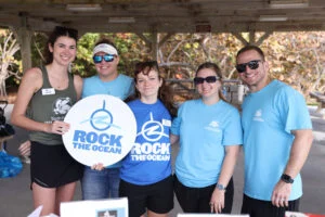 Group Photo with Rock The Ocean sign and South Florida Wildlife Center Staff