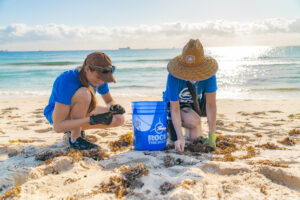 Volunteers picking up microplastic from beach